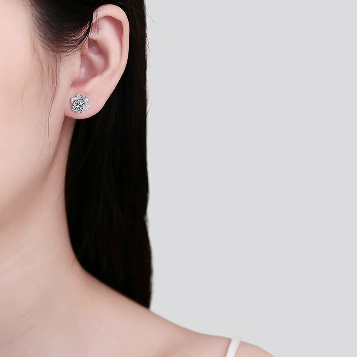 Floral Moissanite Stud Earrings with CZ in Rhodium-Plated S925 sterling silver worn on ear by model showing scale, placement, and stud earrings styling