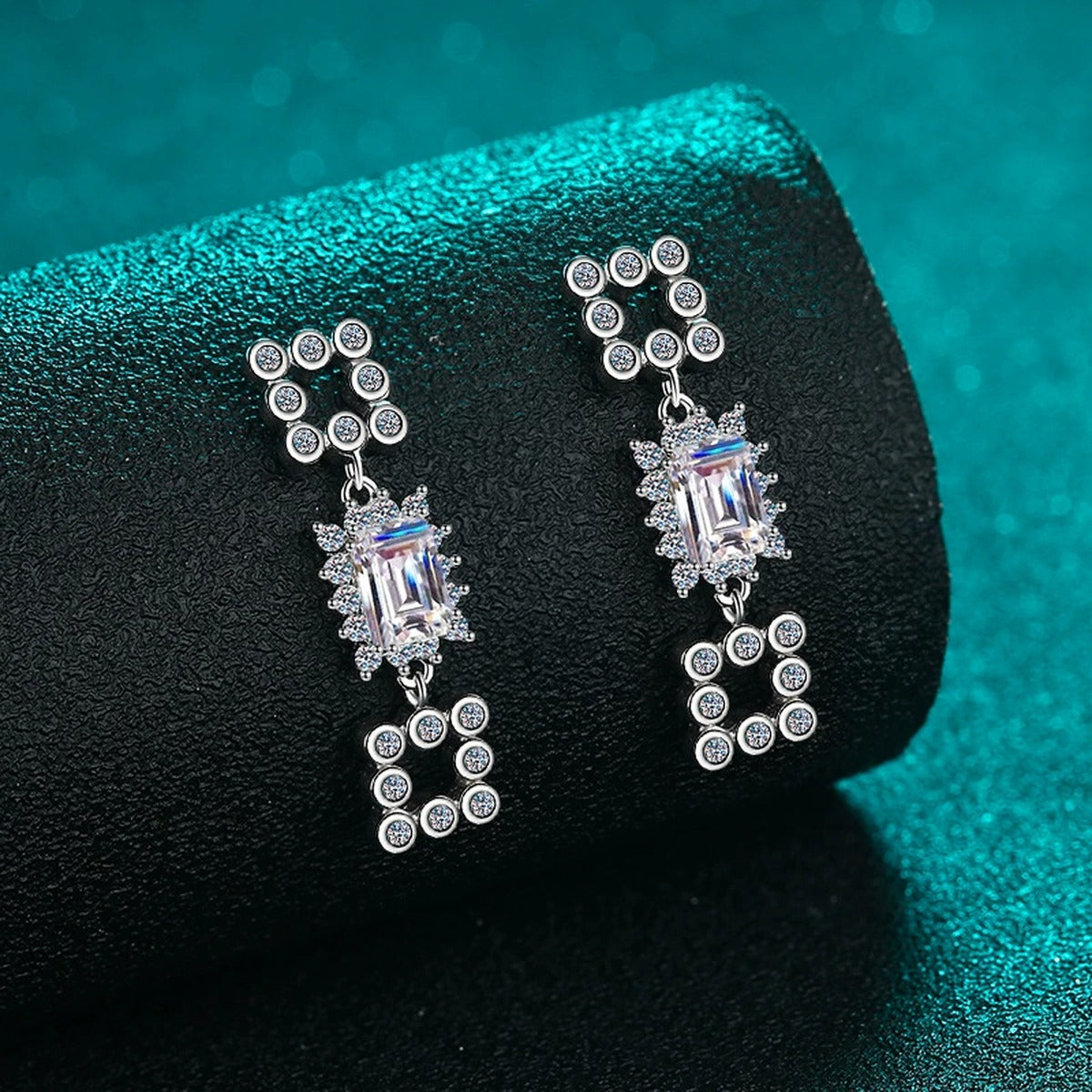 Emerald and Radiant Cut Moissanite Stud Dangle Earrings with CZ in Rhodium-Plated S925 sterling silver product scene view showing angled setting detail