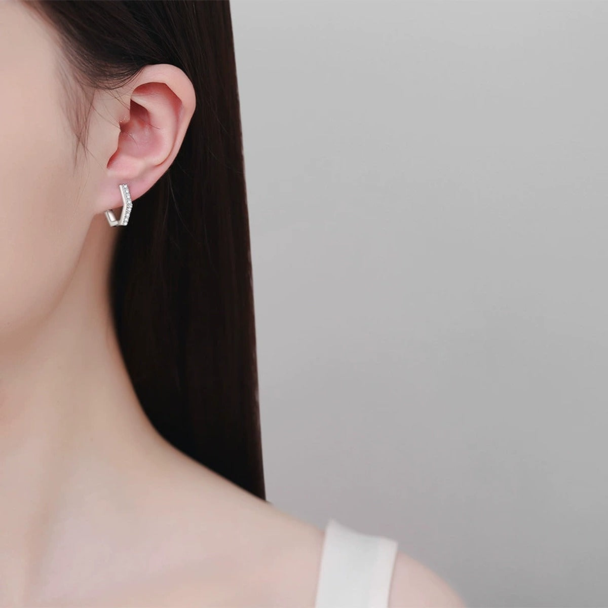 Hexagon Moissanite Hoop Earrings in Rhodium-Plated S925 sterling silver worn on ear by model showing scale, placement, and hoop earrings styling