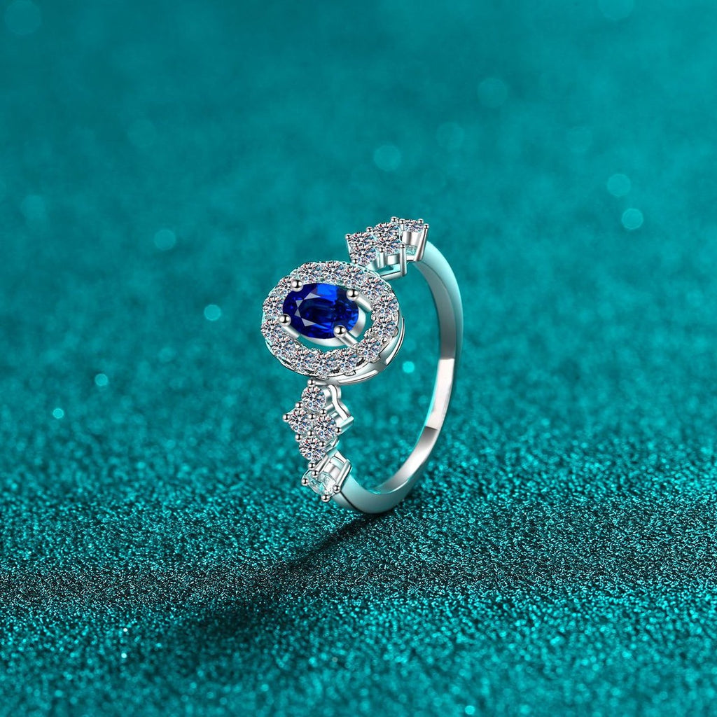 Blue and White Oval Moissanite Ring with CZ in Rhodium-Plated S925 Sterling Silver blue display product photo showing the moissanite setting, stone cut, and band profile