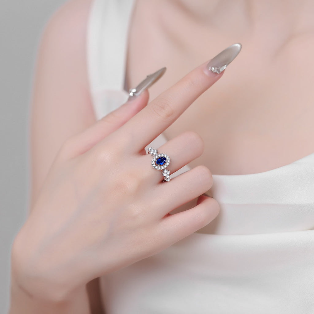 Blue and White Oval Moissanite Ring with CZ in Rhodium-Plated S925 Sterling Silver studio product angle showing the ring setting, stone detail, and band design