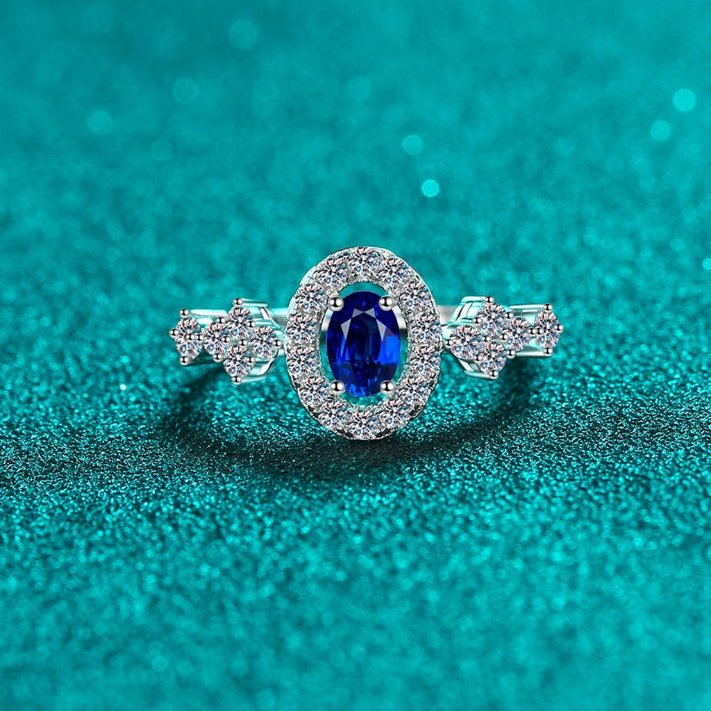 Blue and White Oval Moissanite Ring with CZ in Rhodium-Plated S925 Sterling Silver blue display product photo showing the moissanite setting, stone cut, and band profile