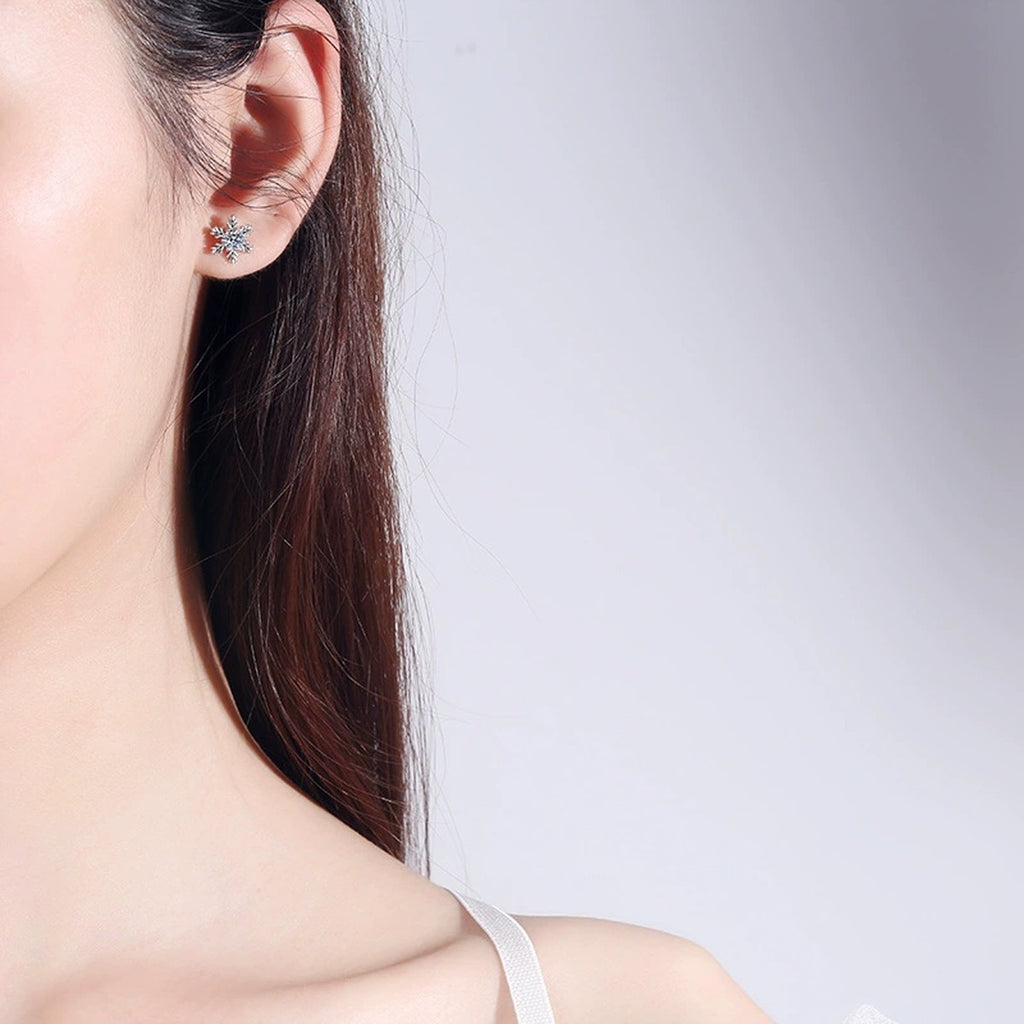 Snowflake Moissanite Stud Earrings in Rhodium-Plated S925 Sterling Silver worn on ear by model to show scale, drop length, and everyday styling