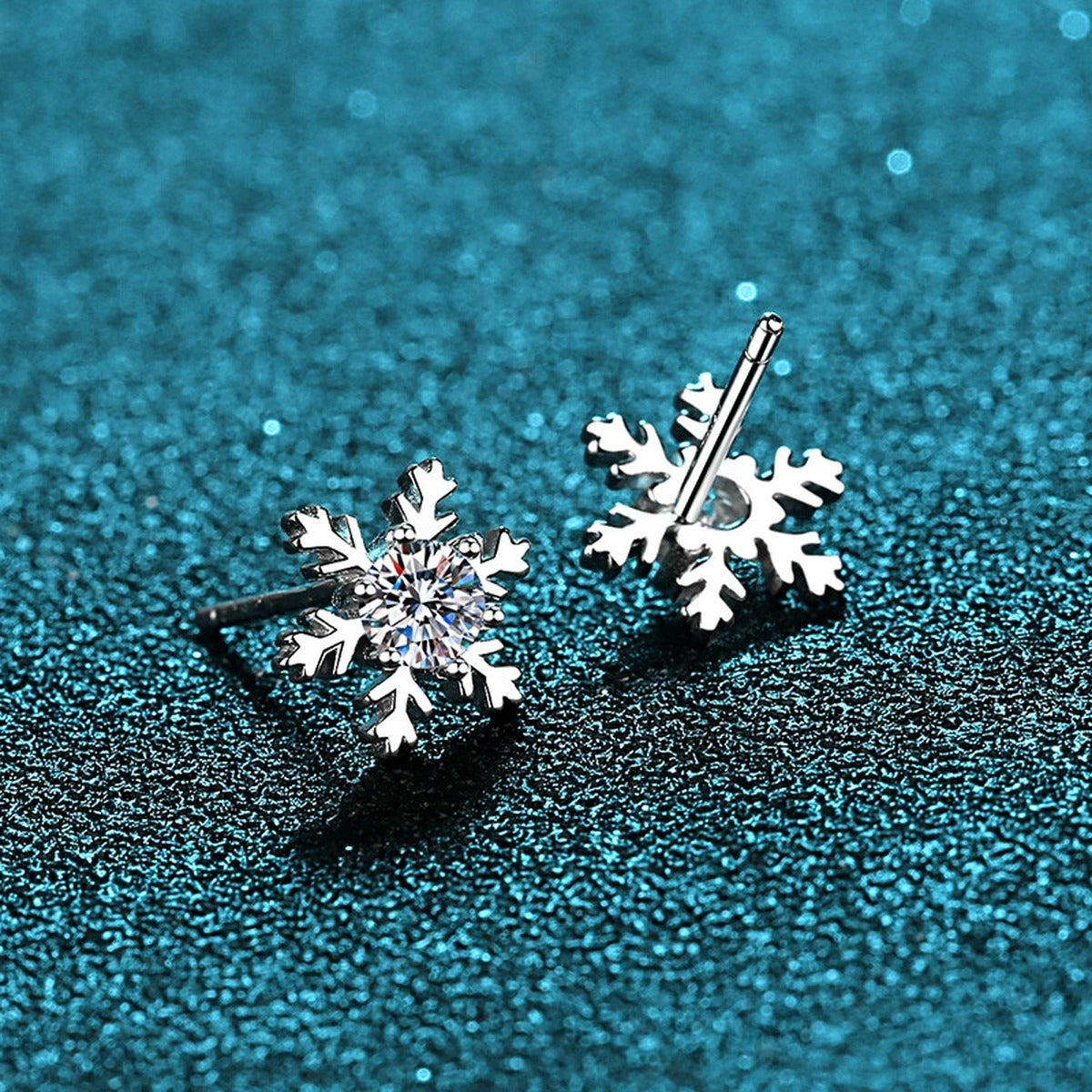 Snowflake Moissanite Stud Earrings in Rhodium-Plated S925 Sterling Silver on blue-green fabric showing front detail