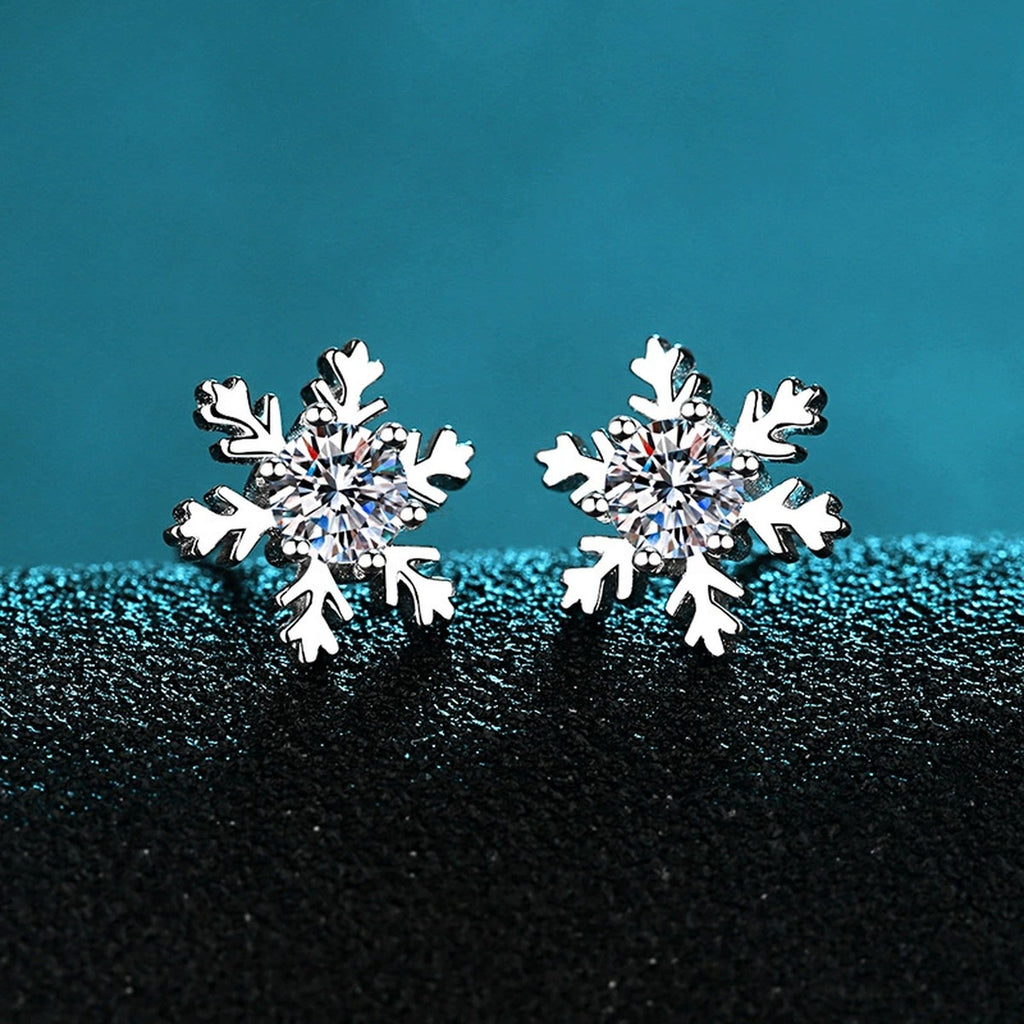 Snowflake Moissanite Stud Earrings in Rhodium-Plated S925 Sterling Silver on blue-green fabric showing angled setting view
