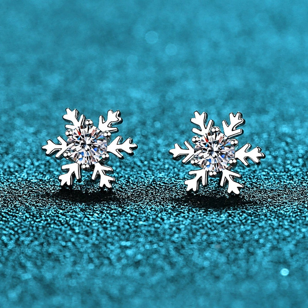 Snowflake Moissanite Stud Earrings in Rhodium-Plated S925 Sterling Silver on blue-green fabric showing side profile and stone setting