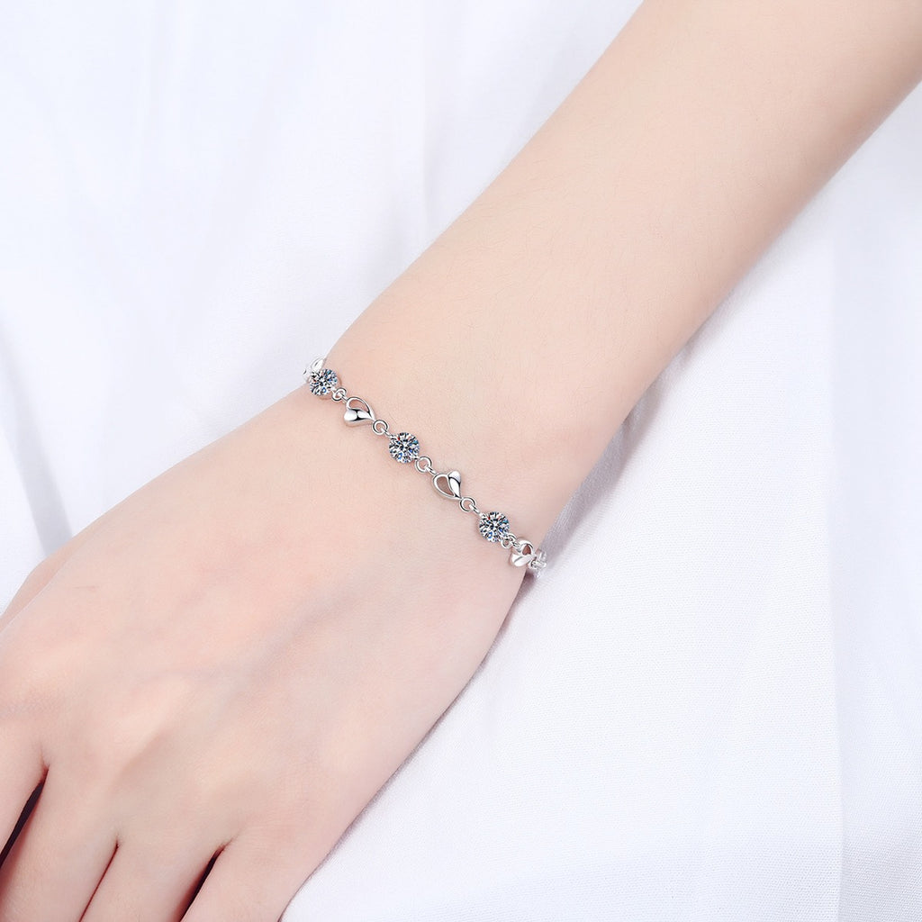 Heart Charm Moissanite Adjustable Bracelet in Rhodium-Plated S925 sterling silver worn on wrist model view showing scale and adjustable fit