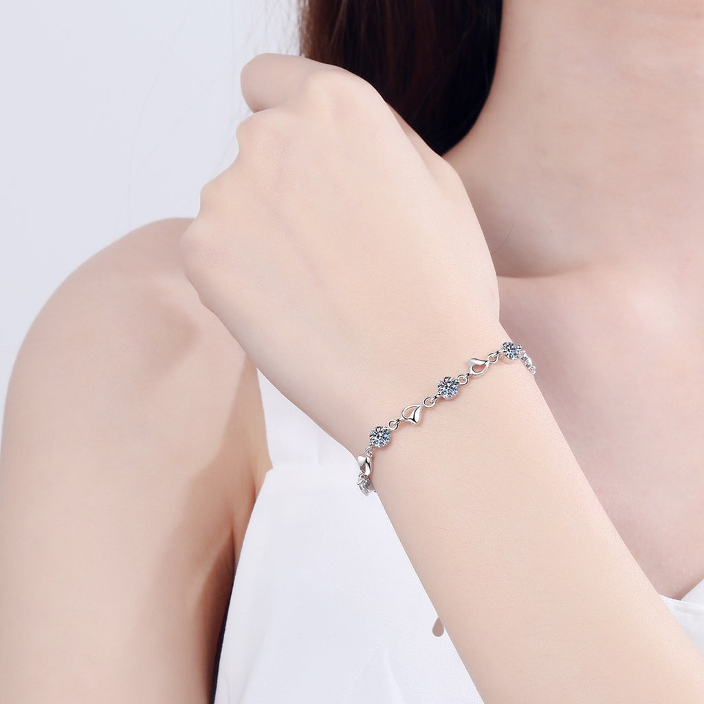 Heart Charm Moissanite Adjustable Bracelet in Rhodium-Plated S925 sterling silver worn on wrist model view showing scale and adjustable fit