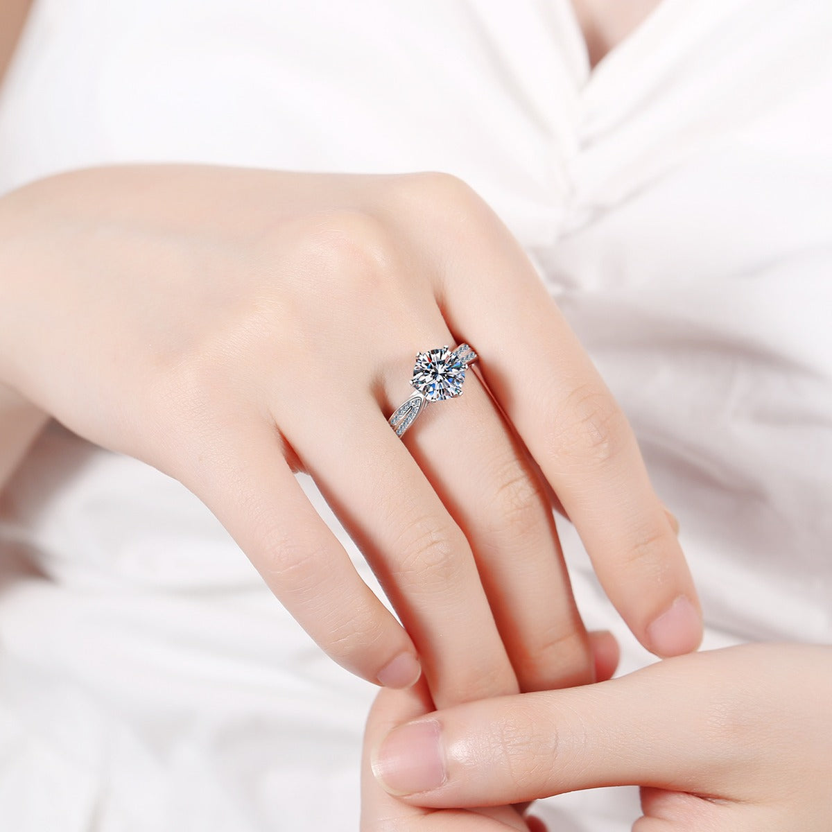 Round Moissanite Side Stone Ring with CZ worn on hand to show scale, band width, and ring profile