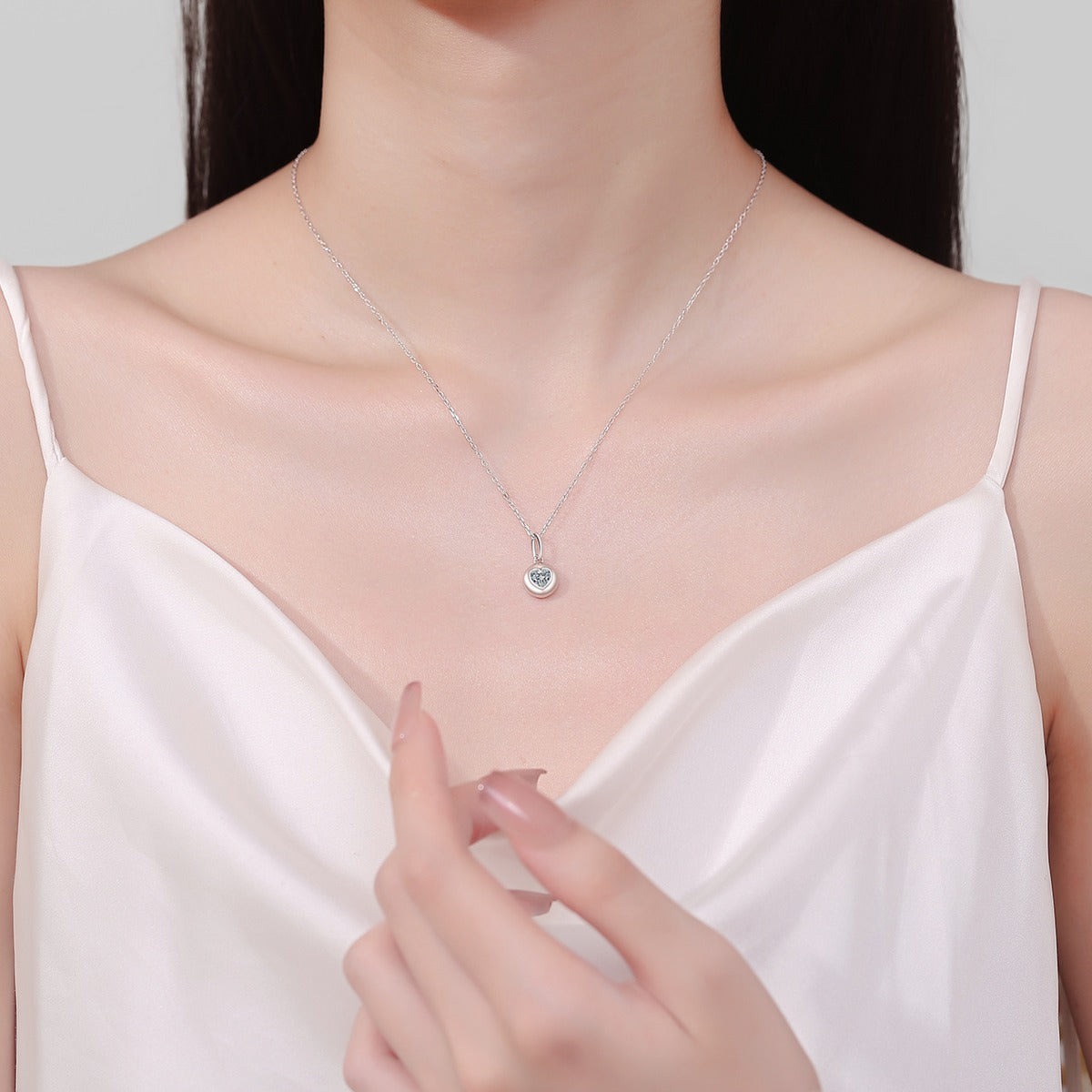 Heart Bead Moissanite Pendant Necklace in Rhodium-Plated S925 sterling silver neckline model view showing pendant scale and adjustable chain