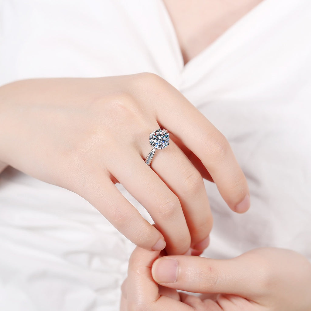 Round Moissanite Solitaire Engagement Ring with CZ worn on hand to show scale, band width, and ring profile