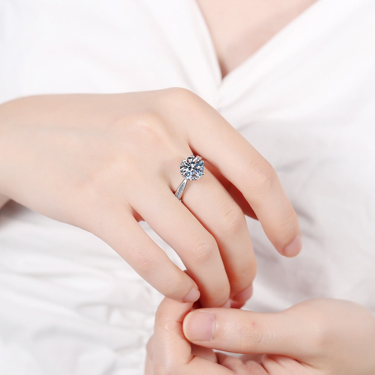Round Moissanite Solitaire Engagement Ring with CZ worn on hand to show scale, band width, and ring profile