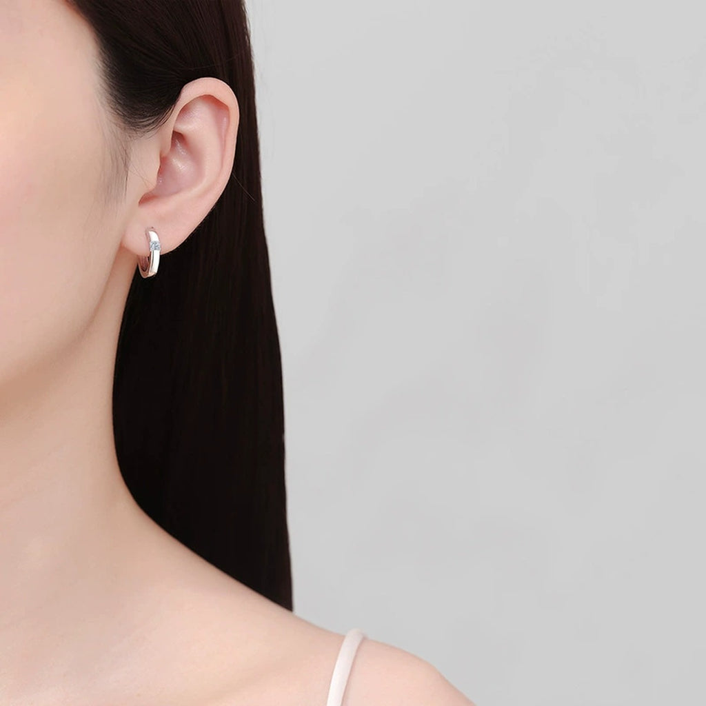 Princess Cut Moissanite Hoop Earrings in Rhodium-Plated S925 sterling silver worn on ear by model showing scale, placement, and hoop earrings styling