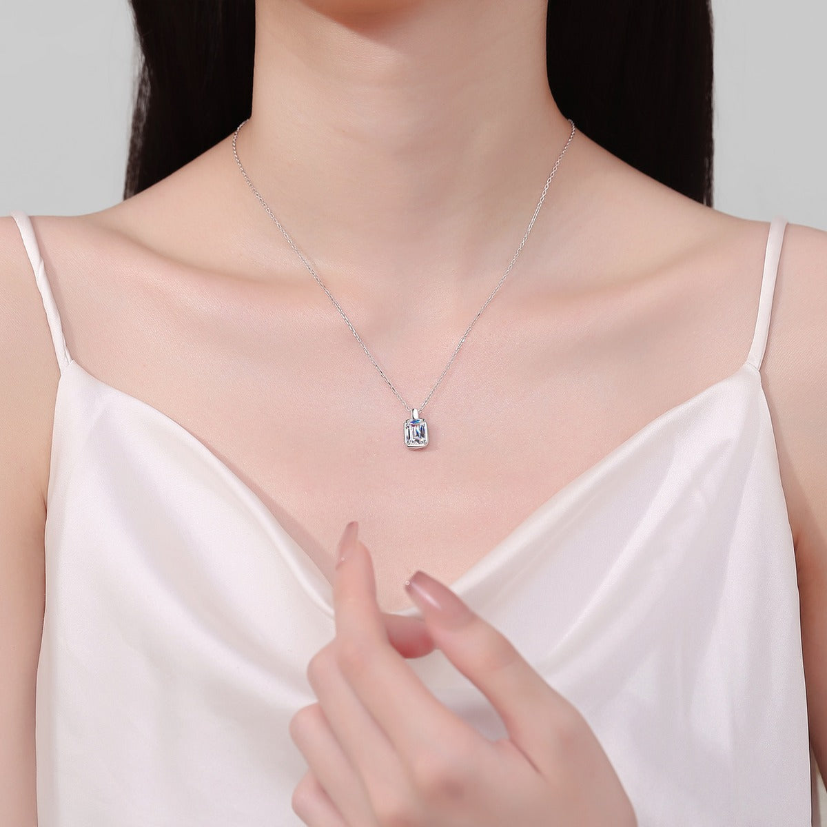 Emerald and Radiant Cut Moissanite Pendant Necklace in Rhodium-Plated S925 sterling silver neckline model view showing pendant scale and adjustable chain