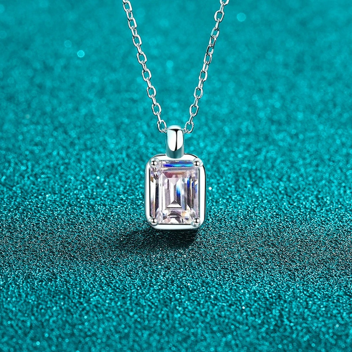 Emerald and Radiant Cut Moissanite Pendant Necklace in Rhodium-Plated S925 sterling silver blue display scene showing chain and stone layout