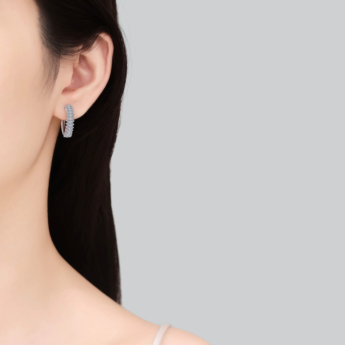 Pave Moissanite Hoop Earrings in Rhodium-Plated S925 sterling silver worn on ear by model showing scale, placement, and hoop earrings styling