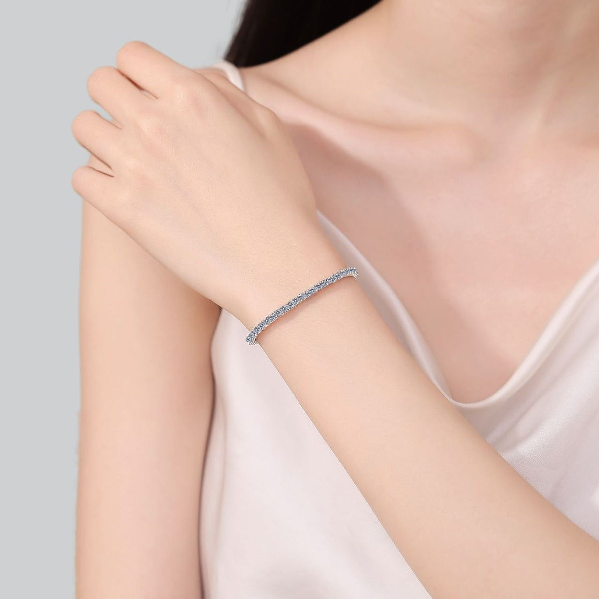 Selectable Stone Size Moissanite Tennis Bracelet in Rhodium-Plated S925 sterling silver worn on wrist model view showing scale and adjustable fit