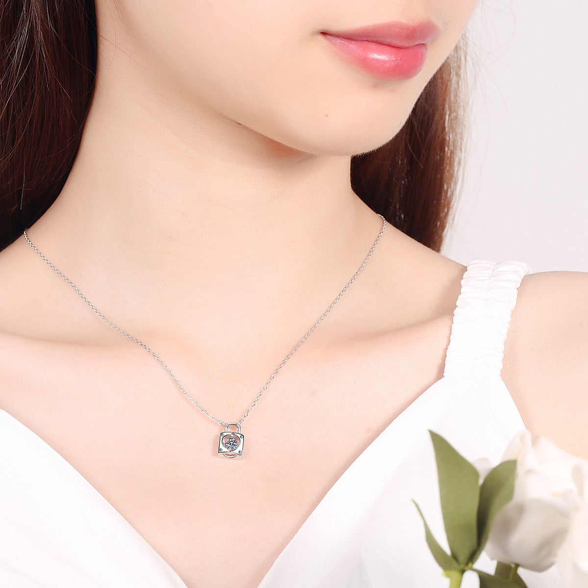 Lock Heart Moissanite Pendant Necklace with CZ in Rhodium-Plated S925 sterling silver worn on neckline by model showing scale and adjustable chain styling