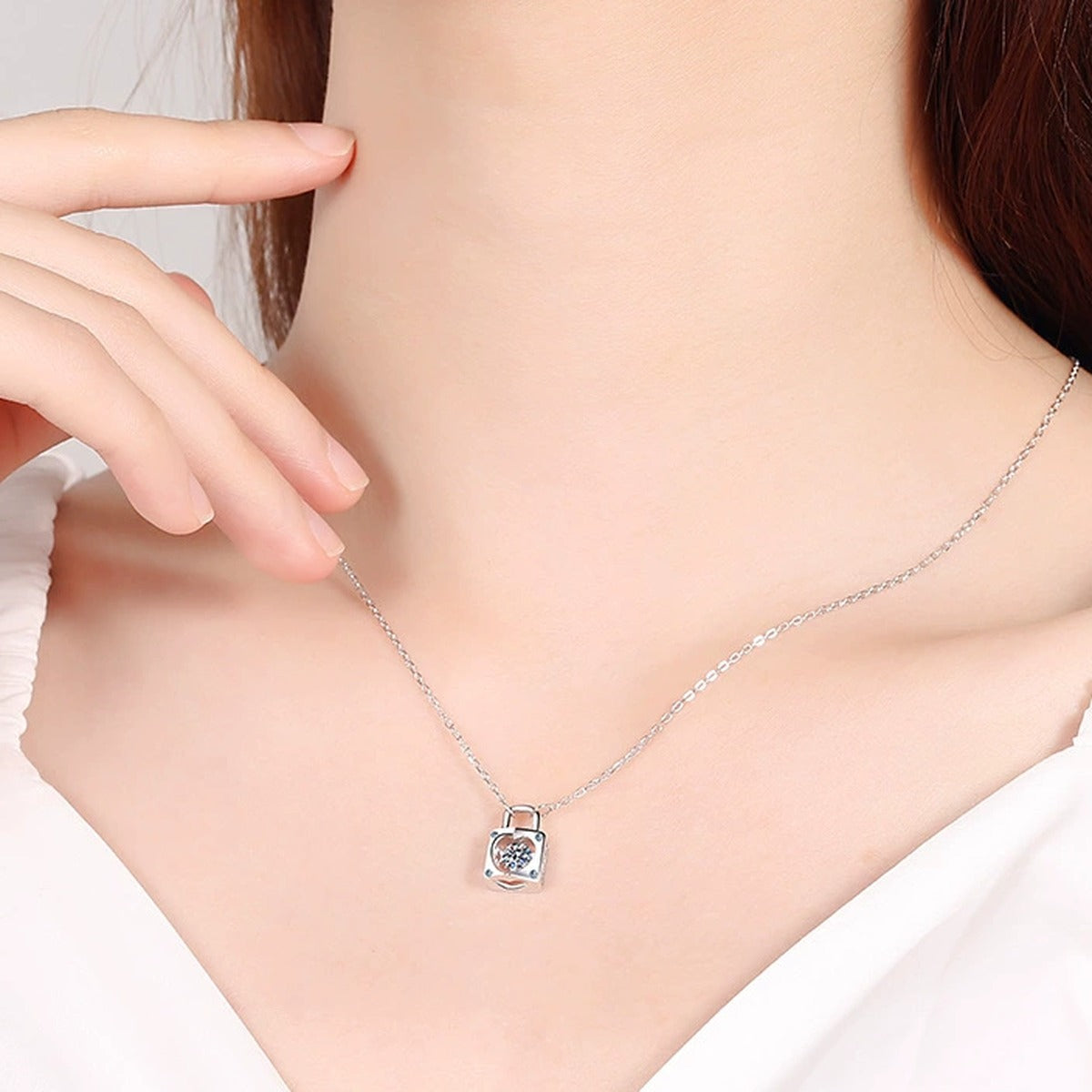 Lock Heart Moissanite Pendant Necklace with CZ in Rhodium-Plated S925 sterling silver worn on neckline by model showing scale and adjustable chain styling