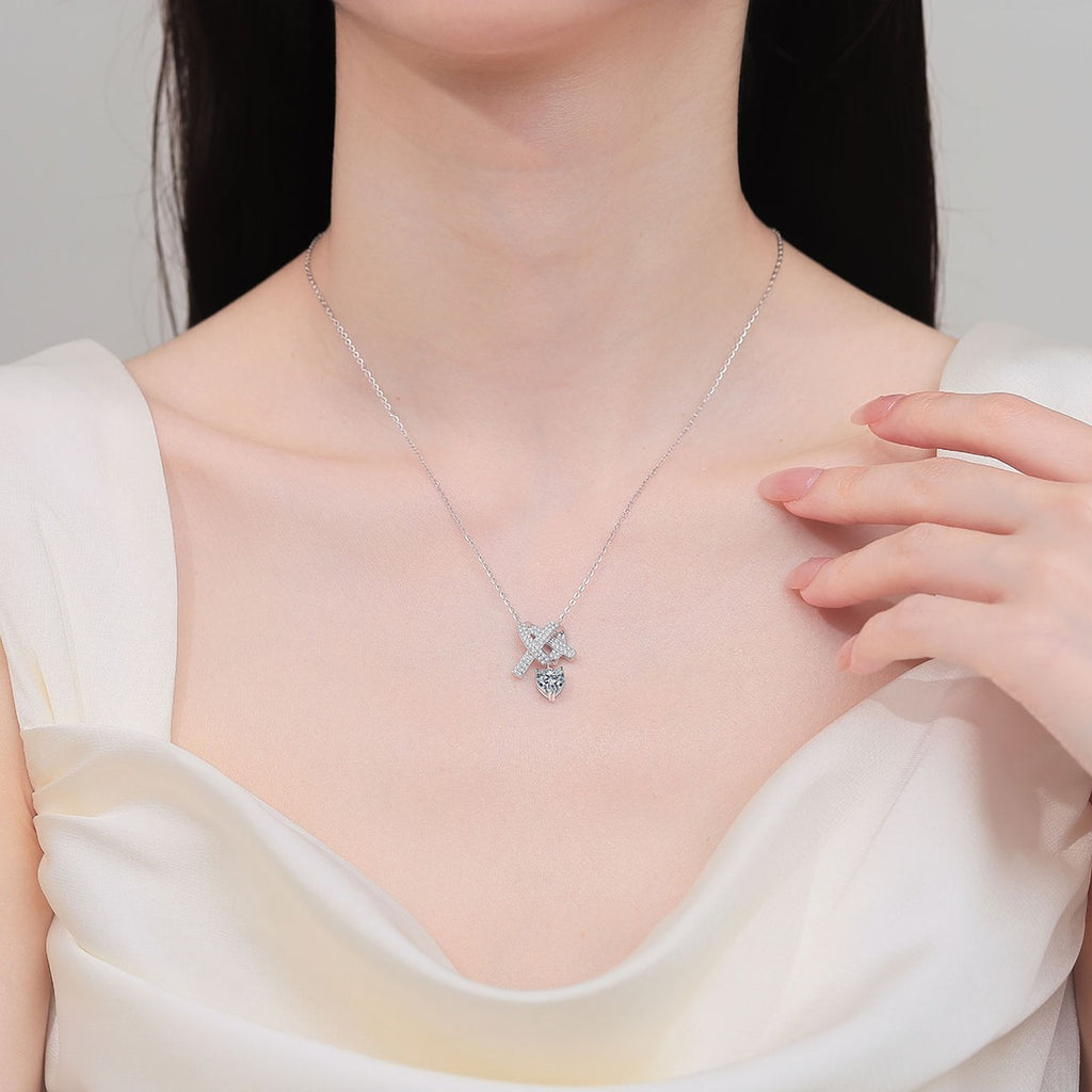 Heart Bow Moissanite Pendant Necklace with CZ in Rhodium-Plated S925 sterling silver neckline model view showing pendant scale and adjustable chain