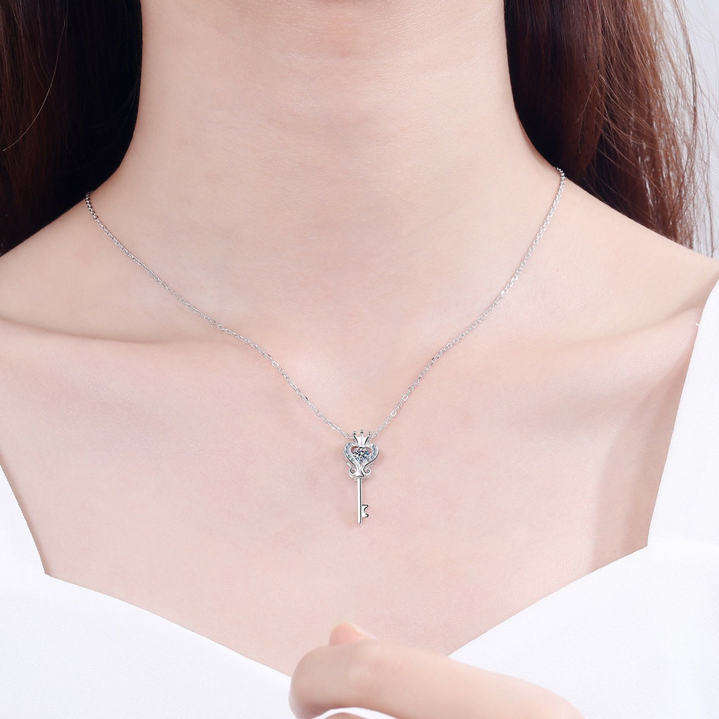 Crown Key Moissanite Pendant Necklace with CZ in Rhodium-Plated S925 sterling silver worn on neckline by model showing scale and adjustable chain styling