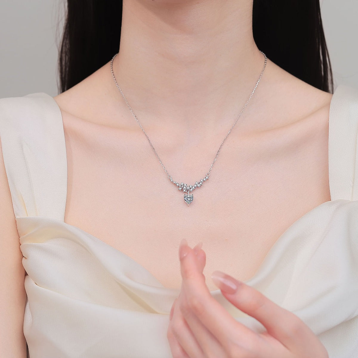Heart Bow Moissanite Pendant Necklace with CZ in Rhodium-Plated S925 sterling silver neckline model view showing pendant scale and adjustable chain