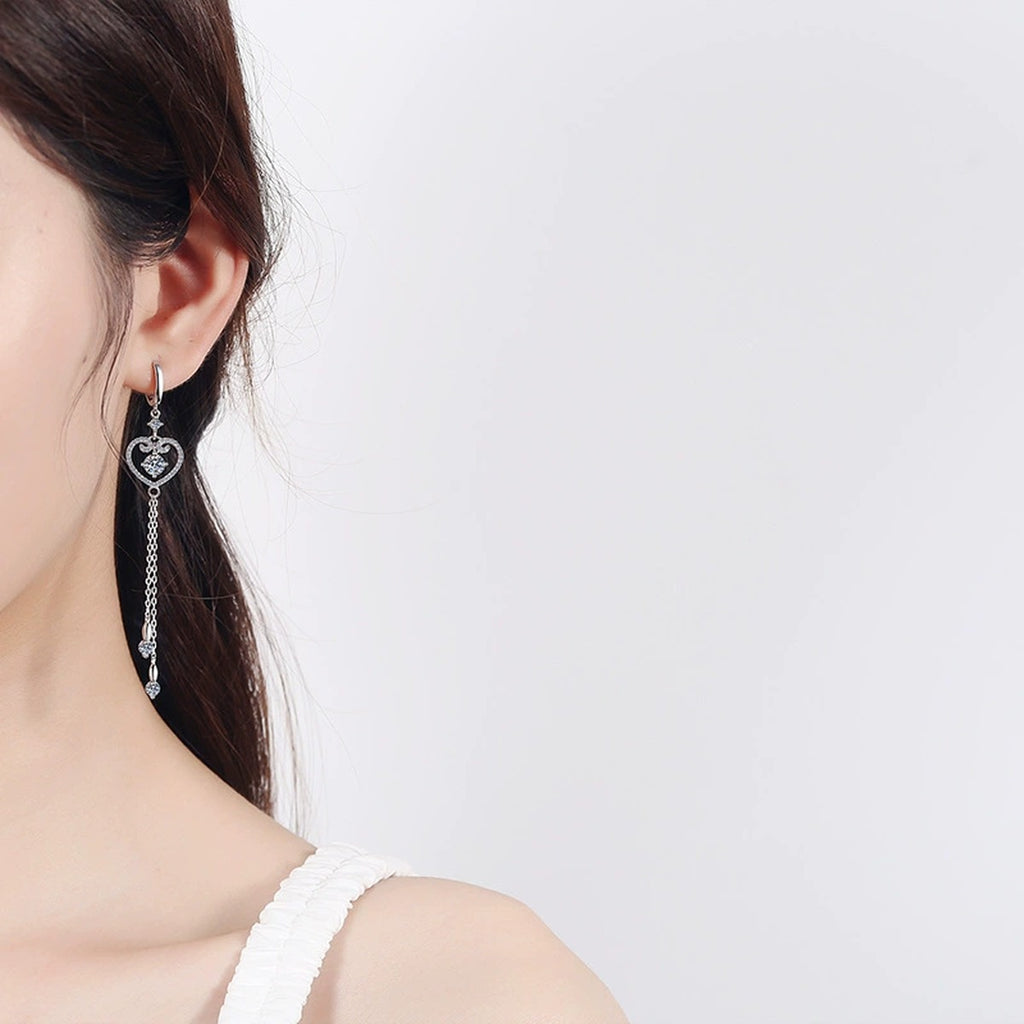Heart Moissanite Hoop Dangle Earrings with CZ in Rhodium-Plated S925 Sterling Silver worn on ear by model to show scale, drop length, and everyday styling