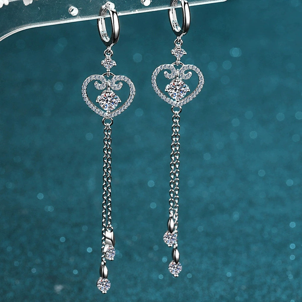 Heart Moissanite Hoop Dangle Earrings with CZ in Rhodium-Plated S925 Sterling Silver on blue-green fabric showing front detail
