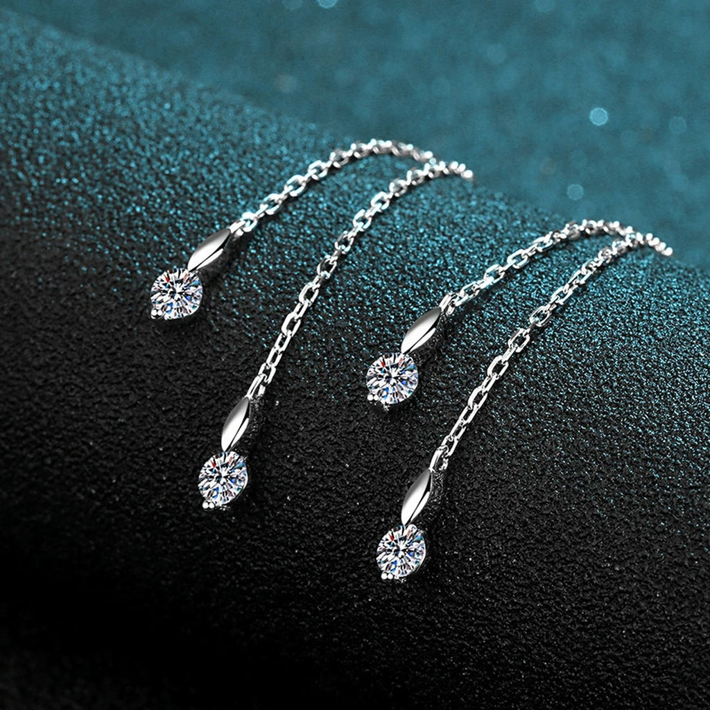 Heart Moissanite Hoop Dangle Earrings with CZ in Rhodium-Plated S925 Sterling Silver on blue-green fabric showing side profile and stone setting