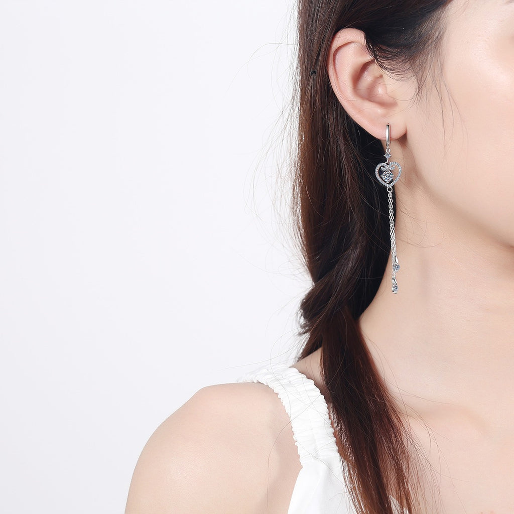 Heart Moissanite Hoop Dangle Earrings with CZ in Rhodium-Plated S925 Sterling Silver worn on ear by model to show scale, drop length, and everyday styling