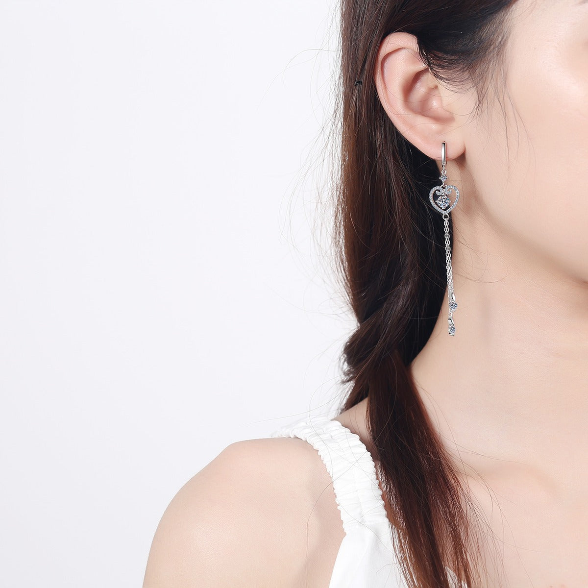 Heart Moissanite Hoop Dangle Earrings with CZ in Rhodium-Plated S925 Sterling Silver worn on ear by model to show scale, drop length, and everyday styling