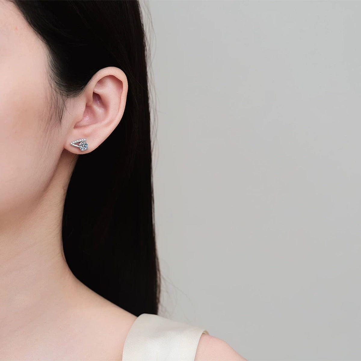 Round Moissanite Stud Earrings with CZ in Rhodium-Plated S925 sterling silver worn on ear by model showing scale, placement, and stud earrings styling