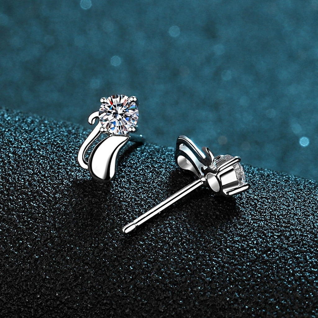Cat Moissanite Stud Earrings in Rhodium-Plated S925 Sterling Silver on blue-green fabric showing front detail