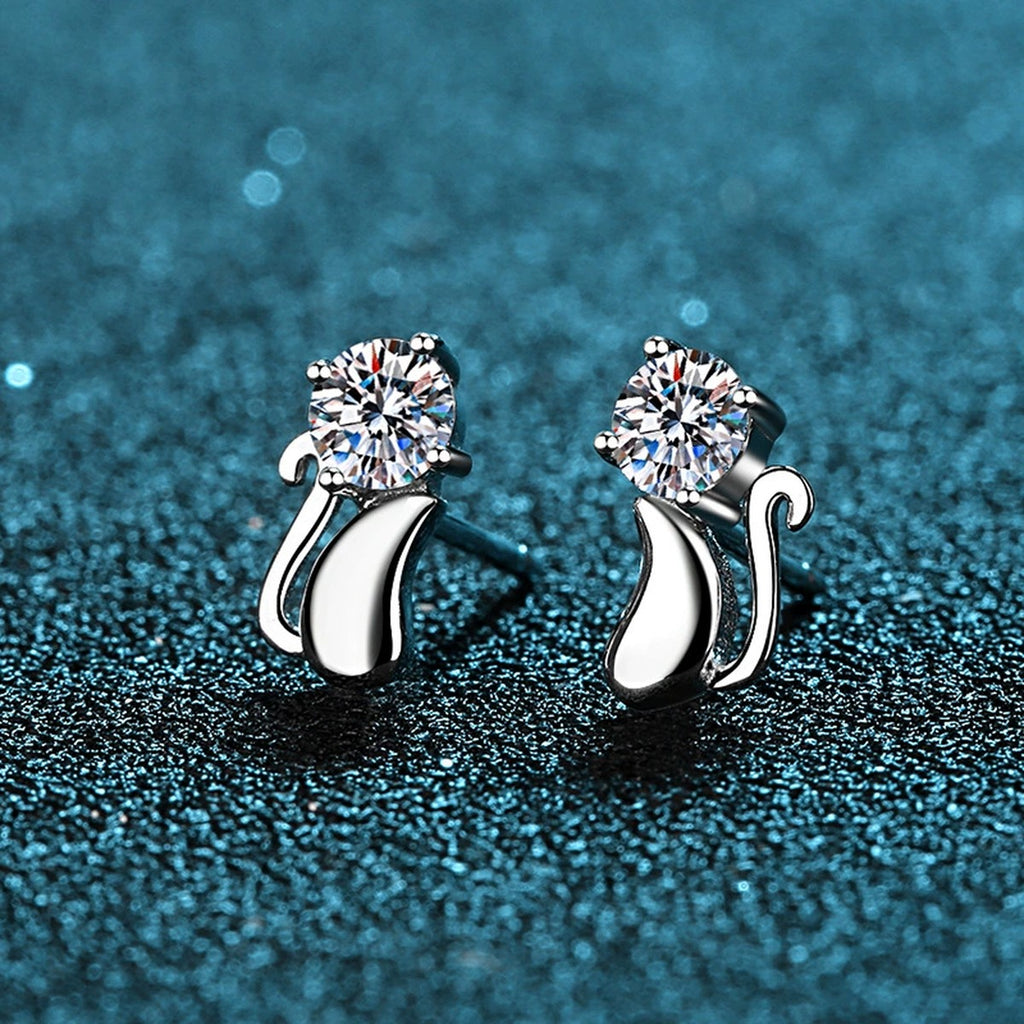 Cat Moissanite Stud Earrings in Rhodium-Plated S925 Sterling Silver on blue-green fabric showing side profile and stone setting