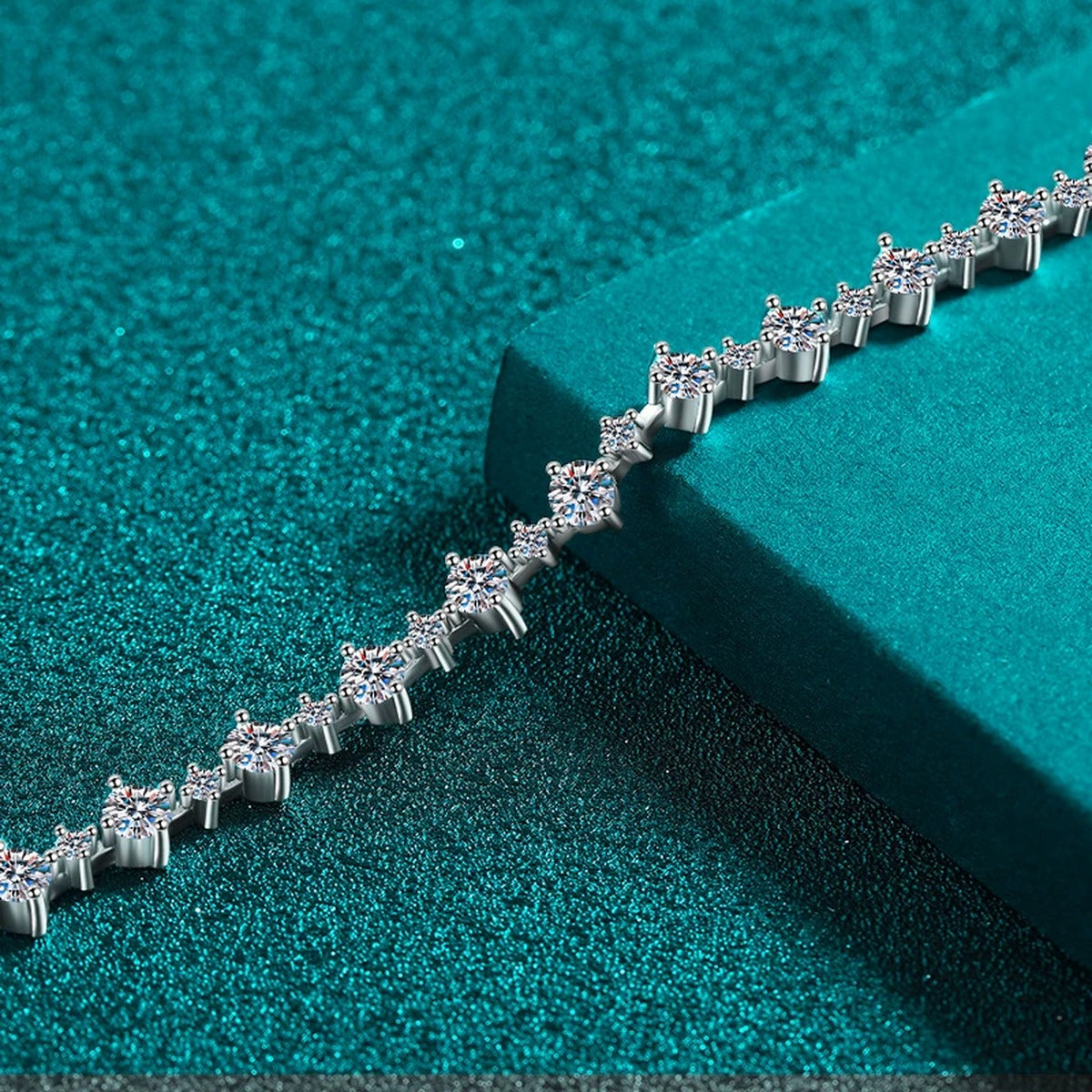 Mixed-Size Round Moissanite Tennis Bracelet in Rhodium-Plated S925 sterling silver angled product display showing bracelet silhouette