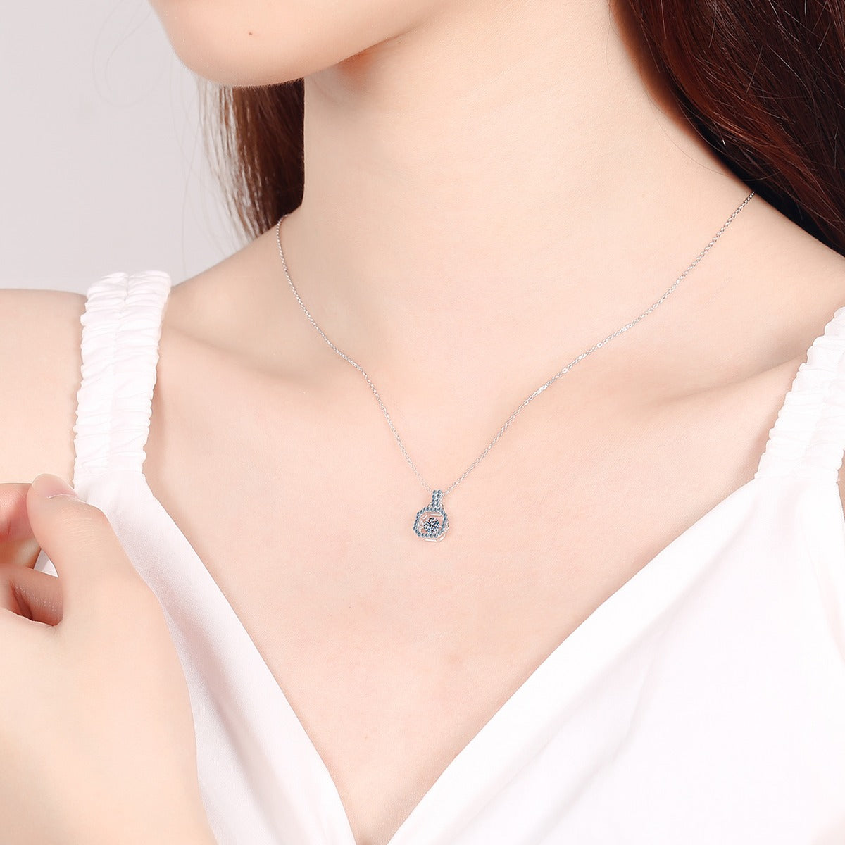 Square Lock Moissanite Pendant Necklace with CZ in Rhodium-Plated S925 sterling silver worn on neckline by model showing scale and adjustable chain styling