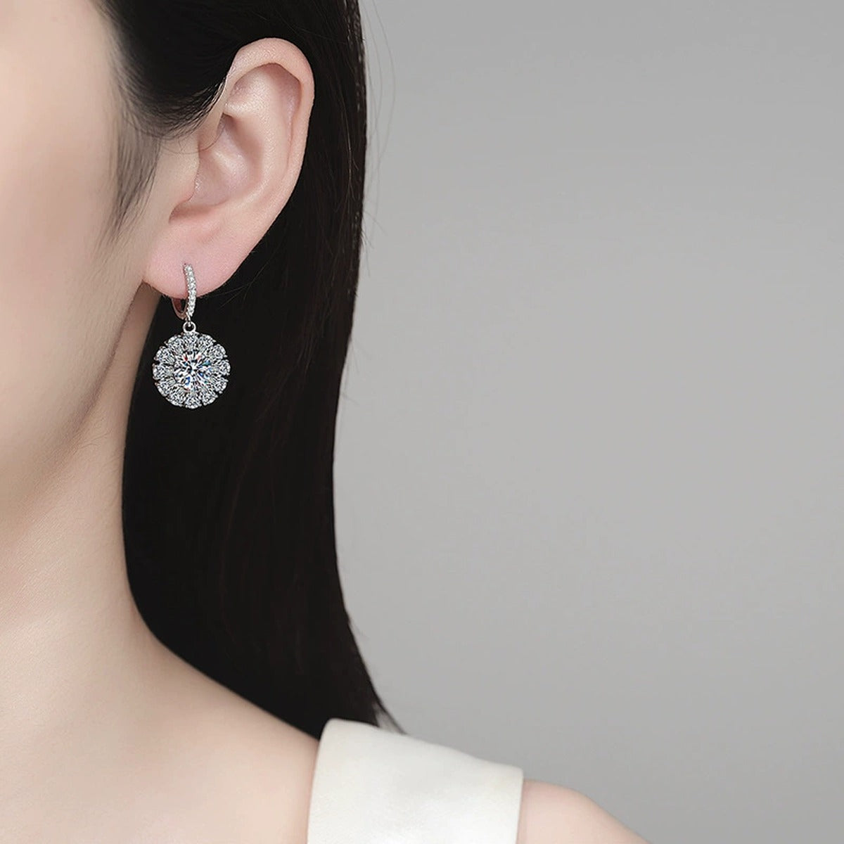 Round Halo Moissanite Hoop Dangle Earrings with CZ in Rhodium-Plated S925 sterling silver worn on ear by model showing scale, placement, and hoop dangle earrings styling