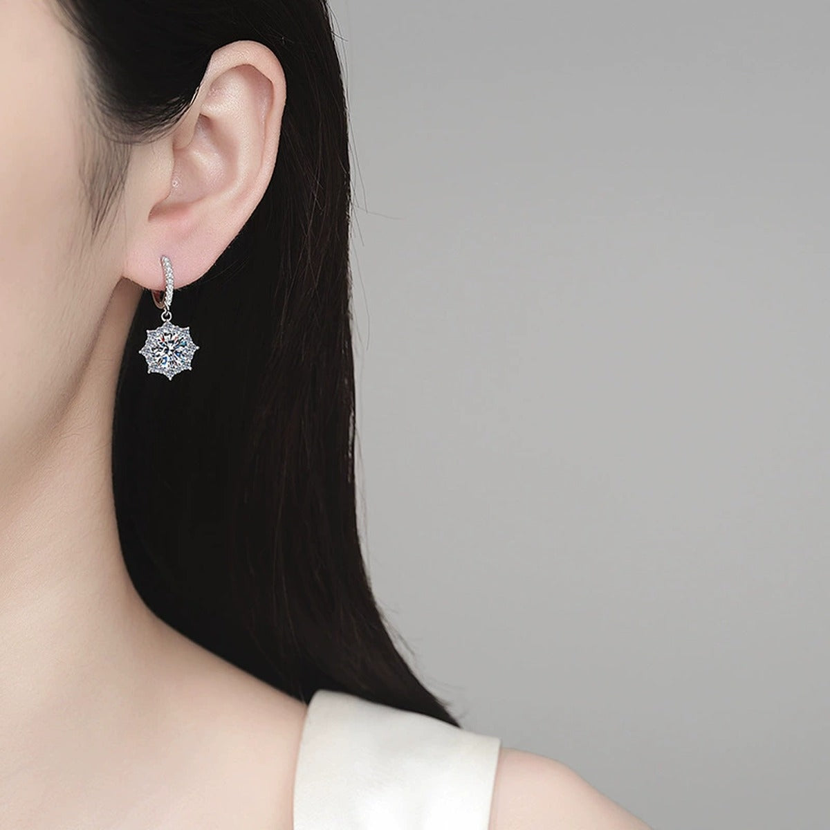Round Halo Moissanite Hoop Dangle Earrings with CZ in Rhodium-Plated S925 sterling silver worn on ear by model showing scale, placement, and hoop dangle earrings styling