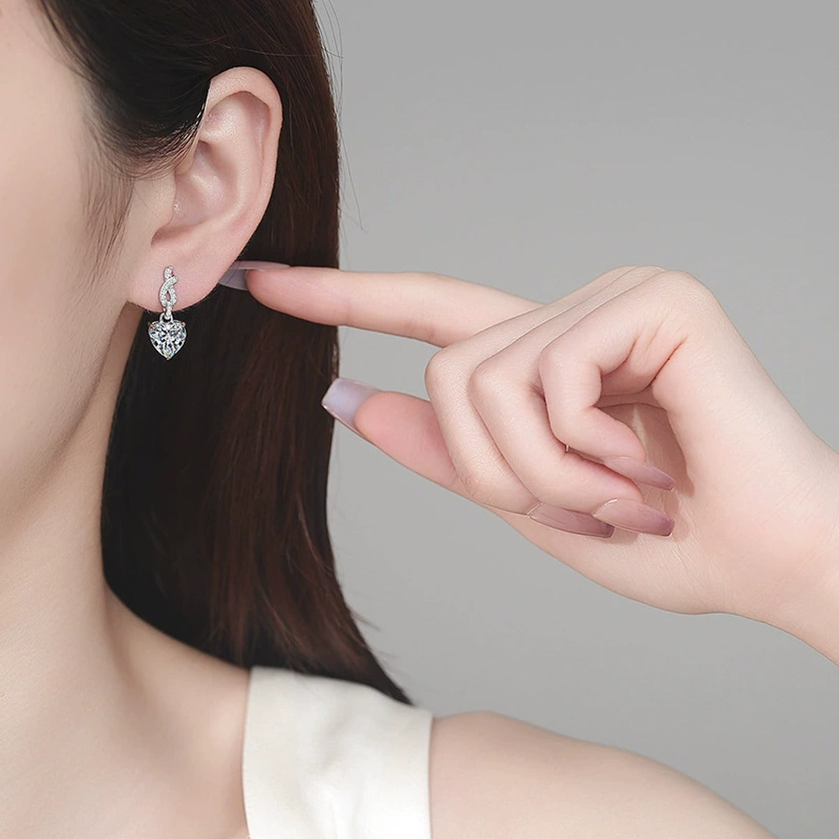 Heart Moissanite Stud Dangle Earrings with CZ in Rhodium-Plated S925 sterling silver worn on ear by model showing scale, placement, and stud dangle earrings styling