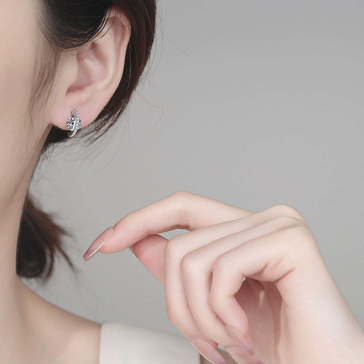 Round Moissanite Stud Earrings with CZ in Rhodium-Plated S925 sterling silver worn on ear by model showing scale, placement, and stud earrings styling