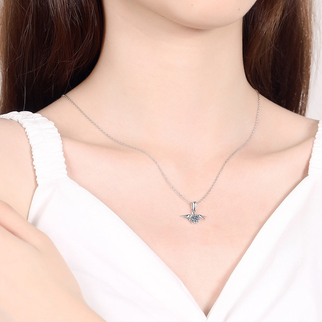 Angel Wing Moissanite Pendant Necklace in Rhodium-Plated S925 sterling silver worn on neckline by model showing scale and adjustable chain styling