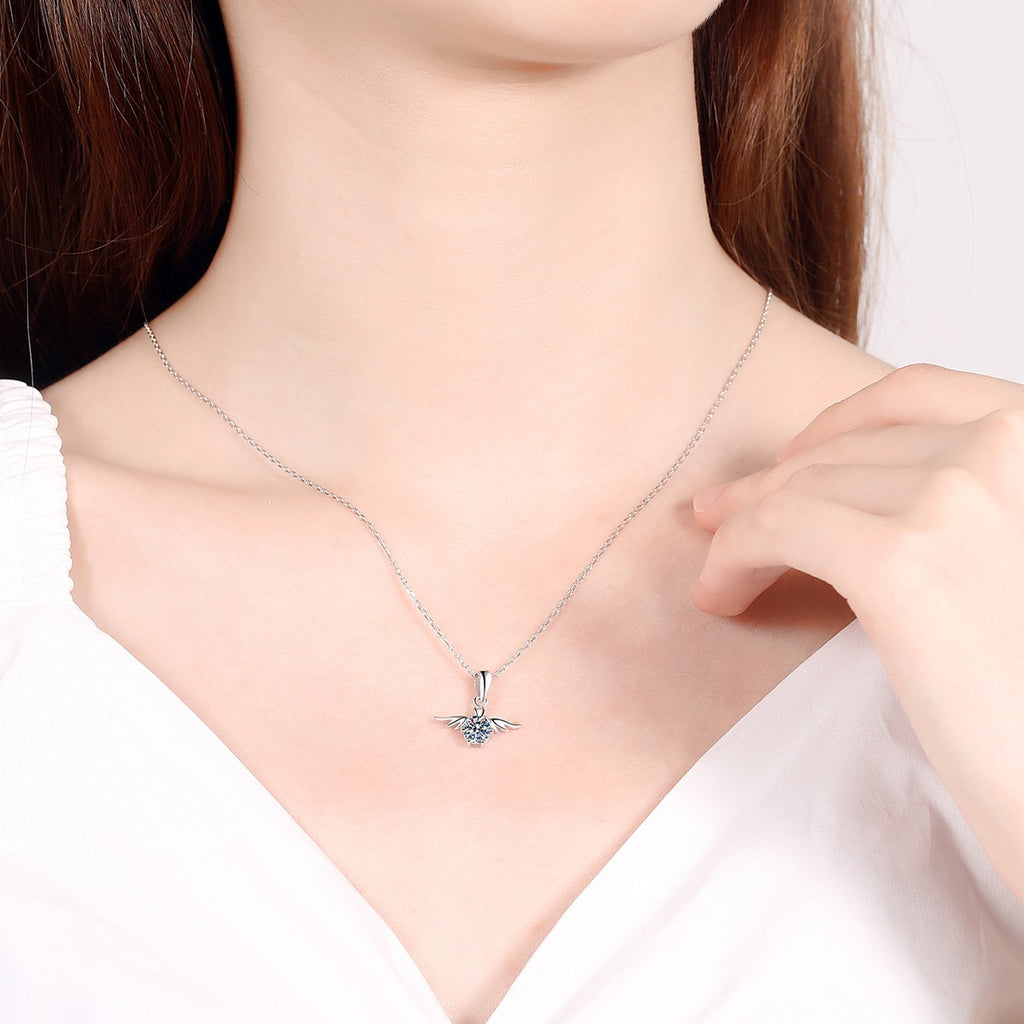 Angel Wing Moissanite Pendant Necklace in Rhodium-Plated S925 sterling silver worn on neckline by model showing scale and adjustable chain styling
