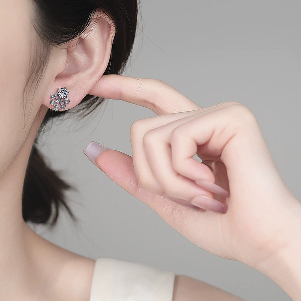 Snowflake Moissanite Stud Earrings with CZ in Rhodium-Plated S925 sterling silver worn on ear by model showing scale, placement, and stud earrings styling