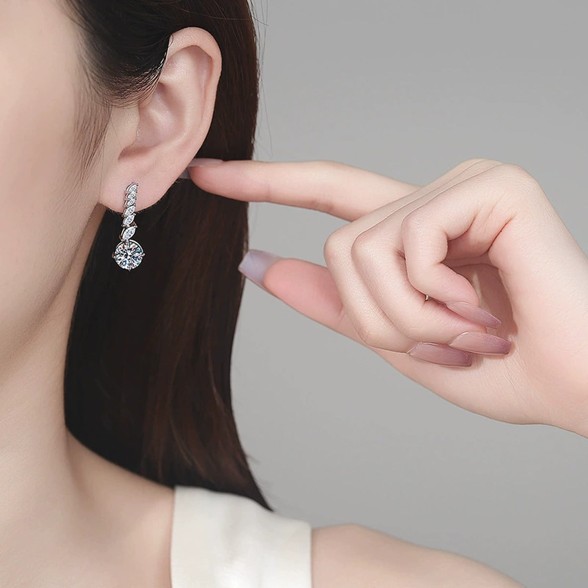 Round Moissanite Stud Drop Earrings with CZ in Rhodium-Plated S925 sterling silver worn on ear by model showing scale, placement, and stud earrings styling