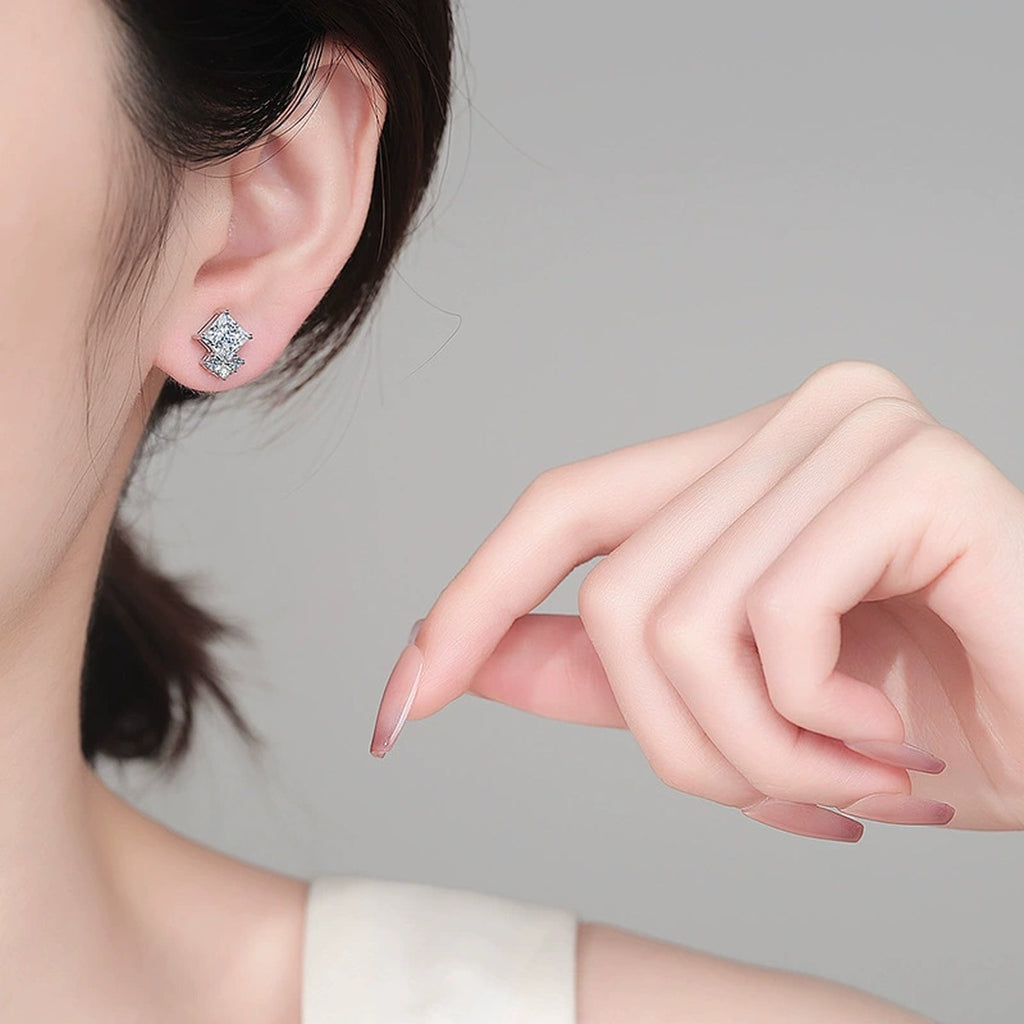 Princess Cut Moissanite Stud Earrings with CZ in Rhodium-Plated S925 sterling silver worn on ear by model showing scale, placement, and stud earrings styling