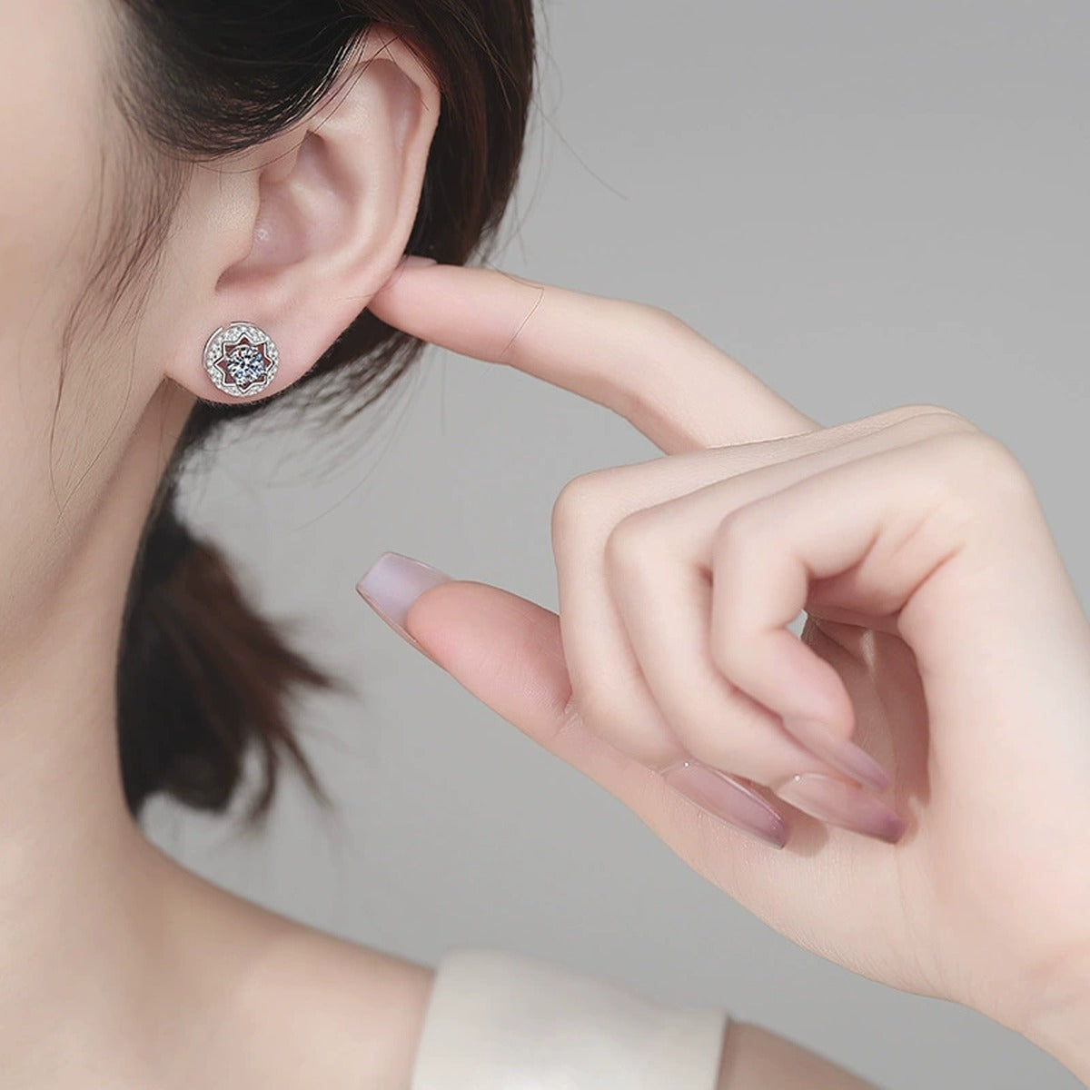 Round Halo Moissanite Stud Earrings with CZ in Rhodium-Plated S925 sterling silver worn on ear by model showing scale, placement, and stud earrings styling