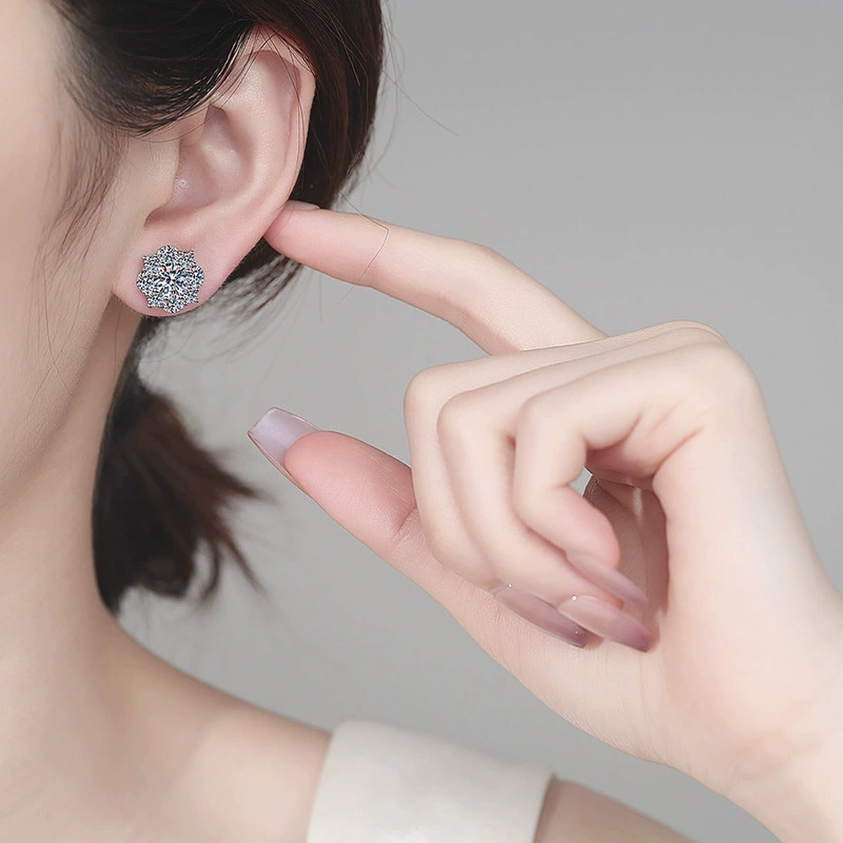 Floral Halo Moissanite Stud Earrings with CZ in Rhodium-Plated S925 sterling silver worn on ear by model showing scale, placement, and stud earrings styling
