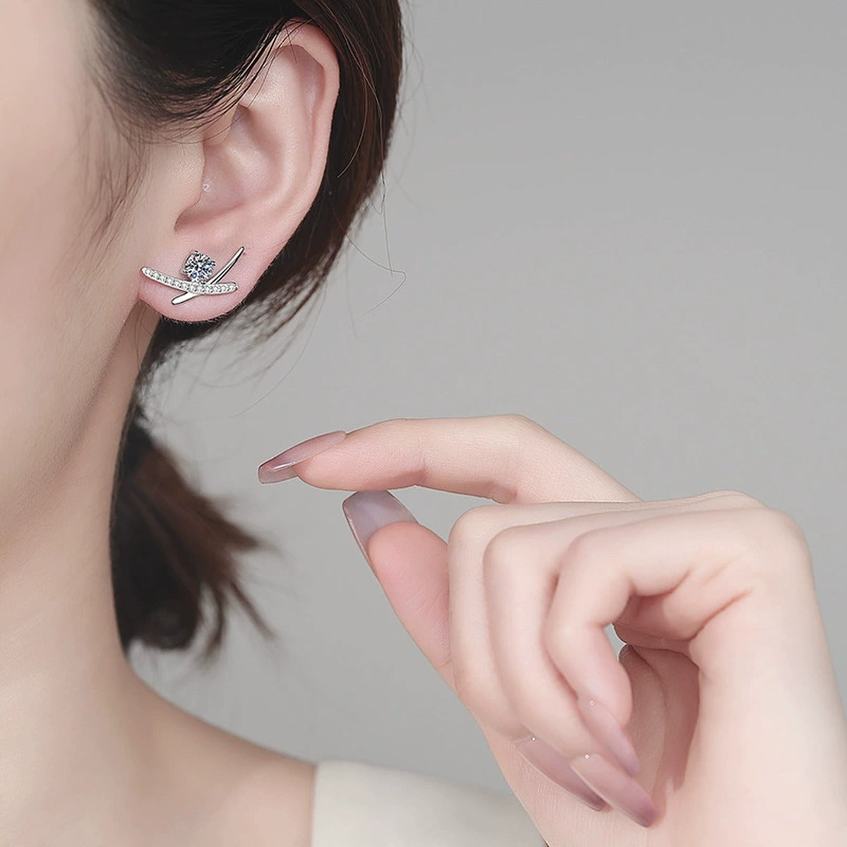 Round Moissanite Ear Climber Stud Earrings with CZ in Rhodium-Plated S925 sterling silver worn on ear by model showing scale, placement, and stud earrings styling