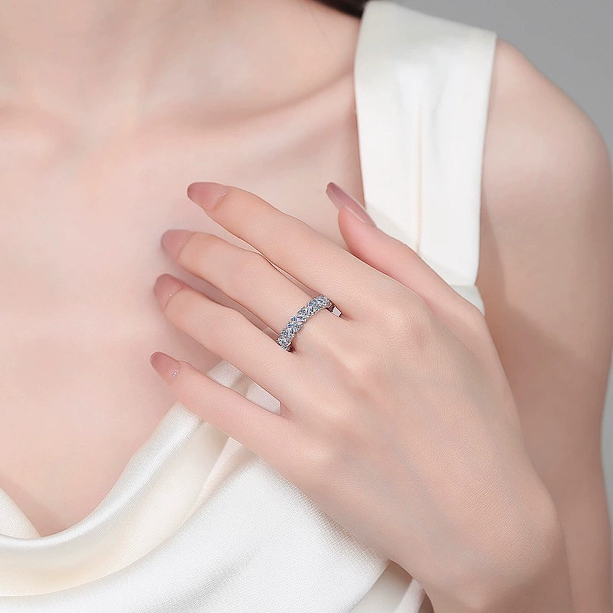 Emerald and Round Moissanite Band Ring worn on hand to show scale, band width, and ring profile