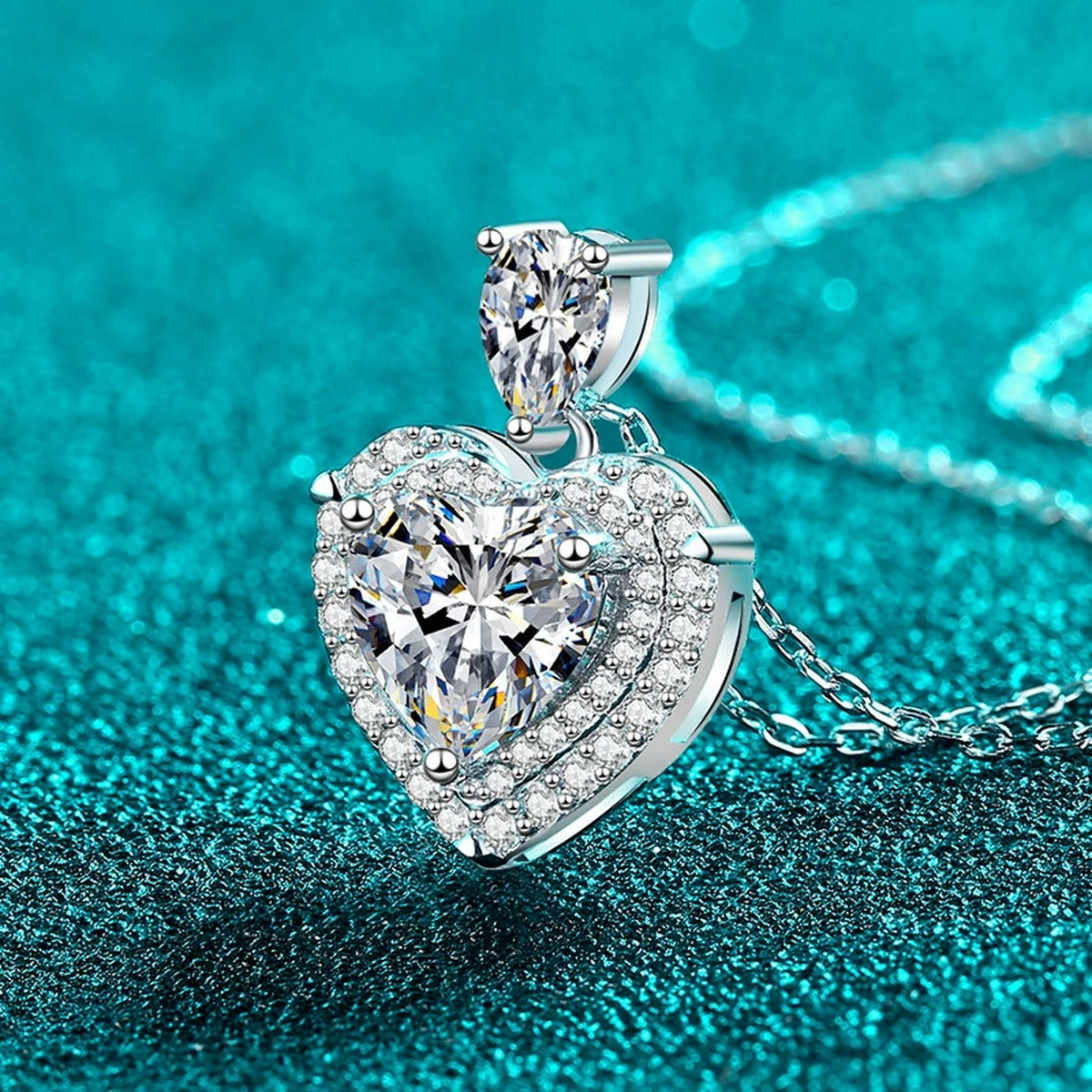 Pear and Heart Moissanite Pendant Necklace with CZ in Rhodium-Plated S925 sterling silver blue display scene showing chain and stone layout